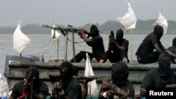 FILE - Militants are seen patrolling the creeks of the Niger delta region of Nigeria, Jan. 30, 2007. A key group, the Niger Delta Avengers, did not send representatives to Tuesday's talks.