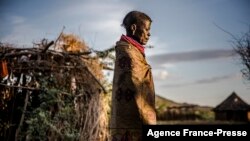 FILE - A woman of the Turkana community walks on her way to her house early in the morning in an arid dry area in Morungole, Turkana county, Kenya, Oct. 4, 2019. 