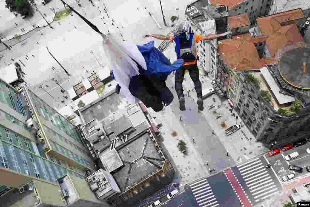 A base jumper leaps from Martinelli building during a competition in Sao Paulo, Brazil, Dec. 4, 2021.