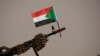 FILE — A Sudanese national flag is attached to a machine gun.