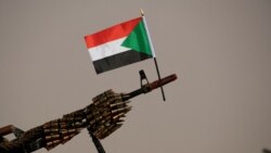 FILE — A Sudanese national flag is attached to a machine gun.