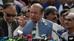 FILE - Nawaz Sharif addresses a crowd during his visit to a mausoleum of Pakistani poet Mohammad Iqbal on the occasion of Pakistan Independence Day in Lahore, Aug. 14, 2017.