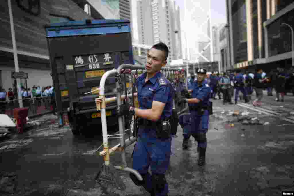 La police démantèle une barricade pendant une manifestation à Admiralty près du siège du gouvernement à Hong Kong, le 14 octobre 2014. 