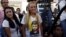 Lilian Tintori (C), wife of jailed opposition leader Leopoldo Lopez, wearing a T-shirt depicting her husband, smiles as she arrives at a news conference in Caracas, Venezuela, Dec. 7, 2015.