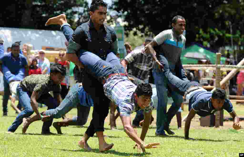 People participate in a traditional game during Sinhala and Tamil New Year celebrations in Colombo, Sri Lanka.&nbsp; Sinhalese and Tamil communities will mark the new year on April 14.