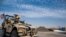 FILE - U.S. forces patrol oil fields in Syria, Oct. 28, 2019.