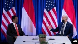 President of Indonesia Joko Widodo, left, listens as U.S. President Joe Biden makes a statement for the press before a bilateral meeting at the COP26 UN Climate Change Conference in Glasgow, Scotland, on Nov. 1, 2021.