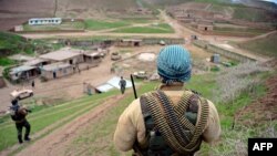 FILE - Afghan Nation Army (ANA) soldiers walk in formation during an operation in Bala Murghab district of Badghis province, March 26, 2017. 