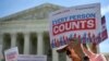 FILE - Demonstrators rally at the U.S. Supreme Court in Washington, April 23, 2019, to protest a proposal to add a citizenship question in the 2020 Census.