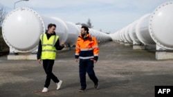EHC Director Sascha Lamme (L) and Tech and Engineering Director of EHC Marinus Van Der Meis (R) walk at the European Hyperloop Center (EHC), in Veendam on March 26, 2024. (Photo by Nick Gammon / AFP)