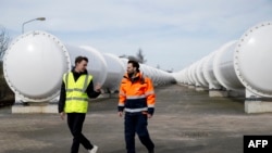 Sascha Lamme, left, and Marinus Van Der Meis walk at the European Hyperloop Center, with a 420m long tunnel serving as a testing facility, on March 26, 2024.