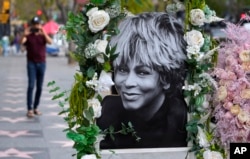 A portrait of the late singer Tina Turner stands atop her star on the Hollywood Walk of Fame, Wednesday, May 24, 2023, in Los Angeles. Turner died Tuesday at 83 after a long illness. (AP Photo/Chris Pizzello)