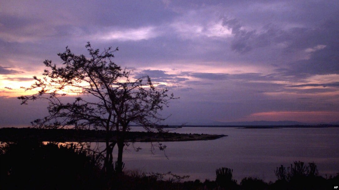 FILE - The sun sets over Lake George near Uganda's Queen Elizabeth National Park in western Uganda.