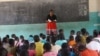 FILE - A teacher talks with students at a class in Nkhatabay district in northern Malawi, in April 2021. The U.S. government handed over 66 secondary schools that it built for students in rural Malawi, on Jan. 30, 2024. (Lameck Masina/VOA)