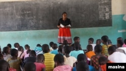 FILE - A teacher talks with a student at a class in a primary school in Nkhatabay district in northen Malawi. (Lameck Masina/VOA)