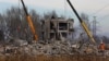 Workers remove debris of a destroyed building purported to be a vocational college used as temporary accommodation for Russian soldiers in Makiivka (Makeyevka), Russian-controlled Ukraine, Jan. 4, 2023. 