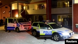 FILE - Swedish police are seen searching for terror suspects at a home in Boliden, northeastern Sweden, Nov. 19, 2015.