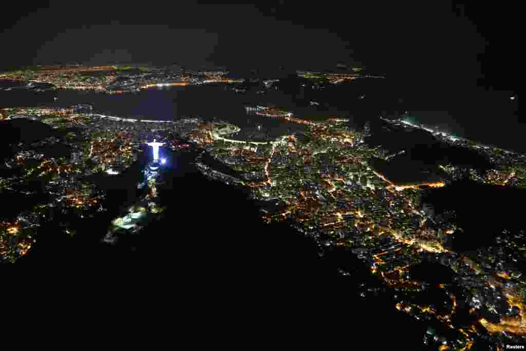 An aerial view of the Christ the Redeemer statue standing above Guanabara Bay, less than two weeks before the start of the Rio 2016 Olympic Games, in Rio de Janeiro, Brazi.