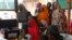 FILE - Women with their children wait to see doctors at a clinic operated by Doctors without Borders in Bagega village in northeastern state of Zamfara, Nigeria, Aug. 14, 2013. 