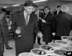 FILE - In this Nov. 5, 1996, photo, Donald Trump, then a real estate mogul and now the U.S. president, visits a reception as he checks out sites in Moscow, Russia, for luxury residential towers.