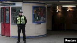 A police officer patrols outside Leytonstone Underground station in east London, Britain, Dec. 6, 2015.