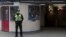 A police officer patrols outside Leytonstone Underground station in east London, Britain, Dec. 6, 2015.