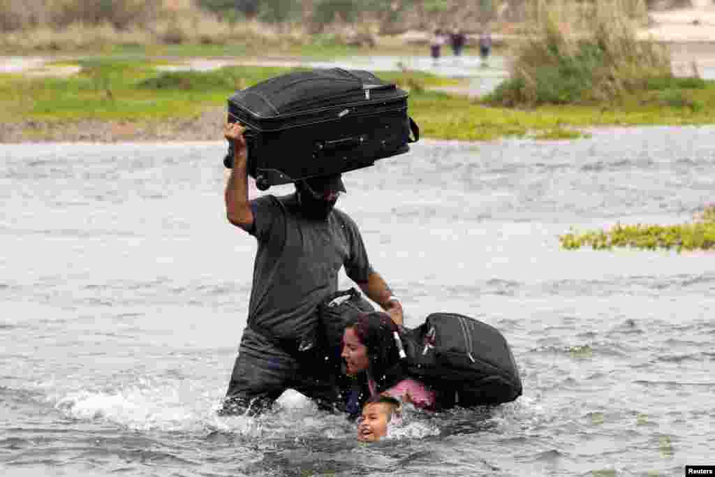 Asylum-seeking migrants from Venezuela cross the Rio Grande river into the United States from Mexico, in Del Rio, Texas, May 10, 2021.