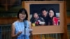 Hua Qu speaks to people attending a vigil for Xiyue Wang at Princeton University in Princeton, N.J. Sept. 15, 2017.