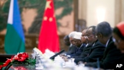 FILE - Djibouti's President Ismail Omar Guelleh, third from right, talks to his Chinese hosts (not pictured) during talks at the Great Hall of the People in Beijing, July 18, 2012.