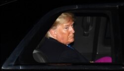 U.S. President Donald Trump leaves in his limousine after a reception at Downing Street, ahead of the NATO summit in Watford, in London, Britain, Dec. 3, 2019.