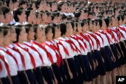 FILE - A North Korean student choir sing as part of the celebrations for the anniversary of the Korean War armistice agreement, July 27, 2014, in Pyongyang, North Korea.