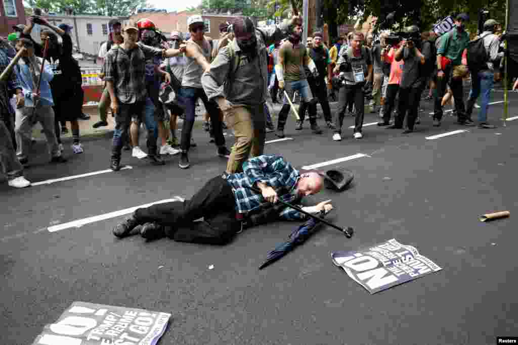 A man is down during a clash between members of white nationalist protesters and a group of counterprotesters in Charlottesville, Va., Aug. 12, 2017. 