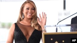 FILE - Mariah Carey attends a ceremony honoring her with a star on the Hollywood Walk of Fame in Los Angeles, Aug. 5, 2015. 