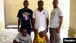 Ex-militants pose for a group photograph in Port Harcourt in the Niger Delta region, Nigeria, April 3, 2011.