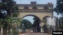 Cattle amble toward an archway at the entrance of former Gambian President Yahya Jammeh's estate in Kanilai, Gambia, July 1, 2017. 