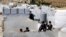 FILE - Displaced Syrian children climb a concrete wall at a refugee camp in the eastern Lebanese border town of Arsal, Lebanon, Aug. 5, 2019. 