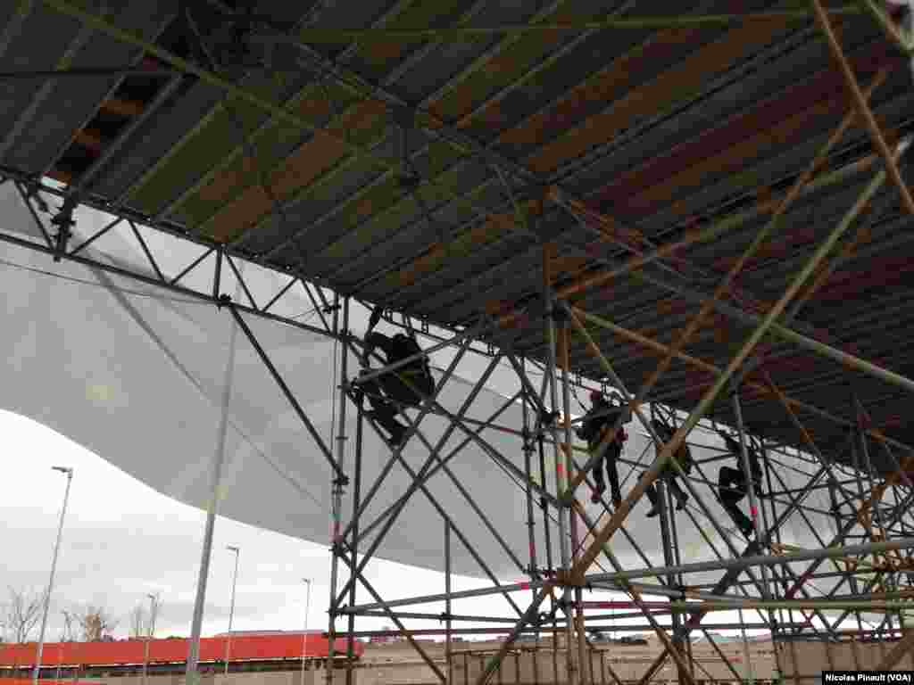 Workers race to complete the partially completed stadium just days before World Cup events start, June 10, 2014. (VOA/Nicolas Pinault)