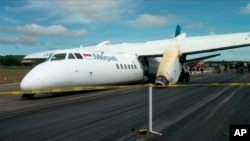 Wreckage of a Chinese-made Xian MA60 twin turboprop aircraft operated by state-run Merpati Nusantara Airlines lies on the runway after it landed hard at El Tari airport in Kupang, East Nusa Tenggara, Indonesia, June 10, 2013.