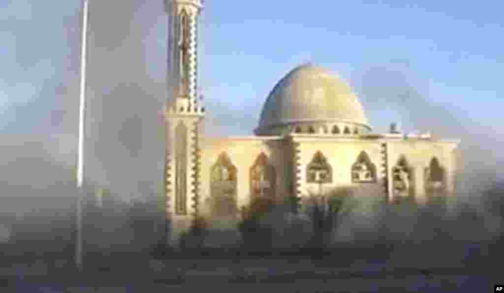 This image from an amateur video purports to show smoke near a mosque in Homs, , February 9, 2012. (AP, via APTN)