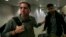 U.S. journalist Glenn Greenwald (L) walks with his partner David Miranda in Rio de Janeiro's International Airport, August 19, 2013. 