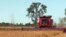FILE - A farmer harvests a field of soybeans near Sioux Falls, South Dakota. 