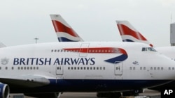 British Airways planes are parked at Heathrow Airport, Jan. 10, 2017.﻿﻿ The airline cancelled flights from two major airports Saturday because, it said, of a power outage.