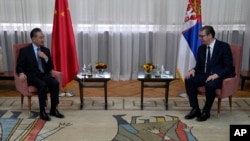 Serbian President Aleksandar Vucic, right, speaks with visiting Chinese Foreign Minister Wang Yi during a meeting at the Serbia Palace in Belgrade, Oct. 28, 2021.