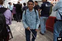In this July 11, 2018 photo, Teodoro Perez Cruz, partially blind, walks around Mexico's President-elect Andres Manuel Lopez Obrador's headquarters. Perez Cruz arrived from Iztapalapa to deliver a letter asking for help in obtaining a house.