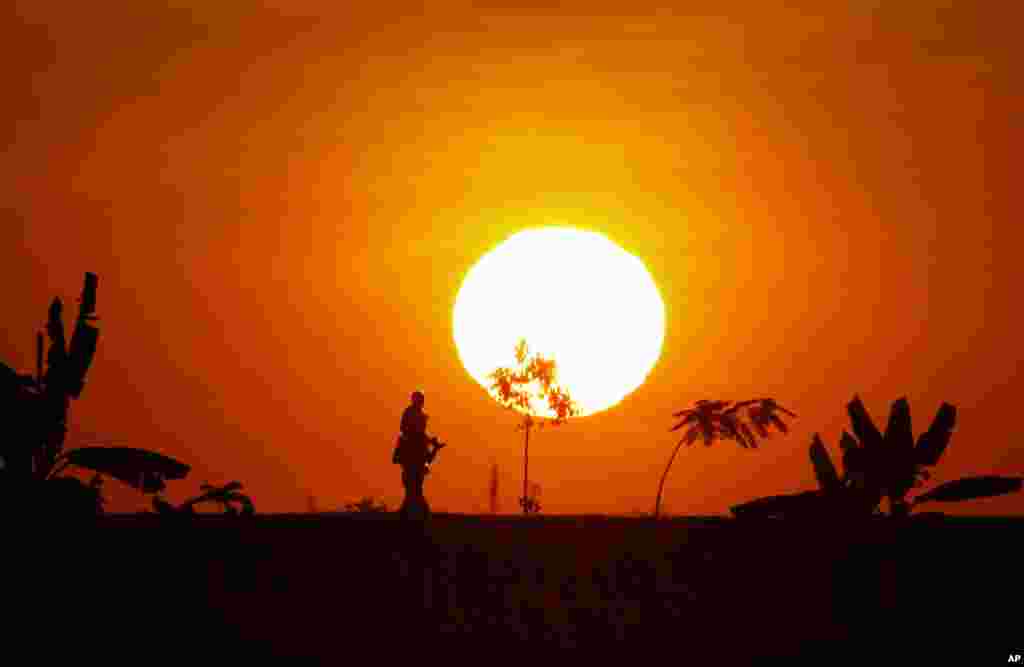 A man and a child walk during sunset in Naypyitaw, Myanmar, Dec. 18, 2016.