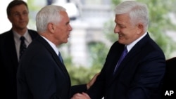 U.S. Vice President Mike Pence, left, shakes hands with Montenegro's Prime Minister Dusko Markovic after a meeting at the White House in Washington, June 5, 2017. Also on Monday, Montenegro formally became the 29th member of NATO during a State Department ceremony.