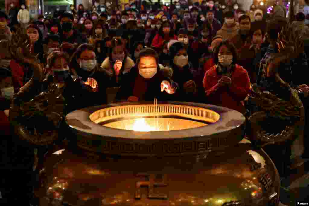 People pray at the temple to celebrate Lunar New Year in New Taipei City, Taiwan, Jan. 31, 2022.