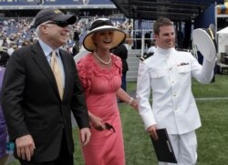 FILE - Sen. John McCain, R-Ariz., left, and his wife, Cindy, walk with their son Jack after he graduated from the U.S. Naval Academy in Annapolis, Md., May 22, 2009.