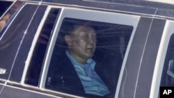 Impeached South Korean President Yoon Suk Yeol sits in a car as he heads to a detention center in Uiwang, South Korea, Jan. 15, 2025. 