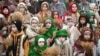 Children wearing traditional clothes carry 'didukh' as they take part in a Christmas Eve procession in Lviv, Dec. 24, 2024, amid the Russian invasion of Ukraine. 